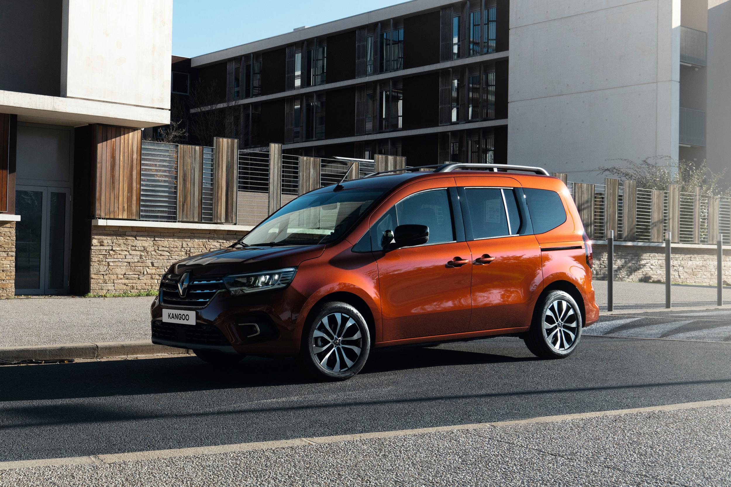 Terracotta Brown rudos spalvos Renault KANGOO vienatūris, pastatytas gatvėje šalia šaligatvio